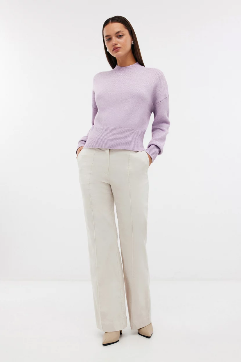Periwinkle sweater with cream trousers
